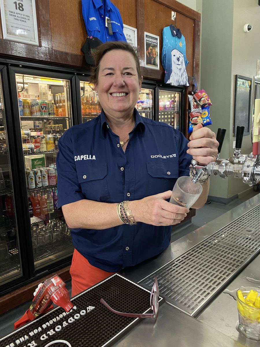 Pouring a beer behind the bar at Dooleys Capella