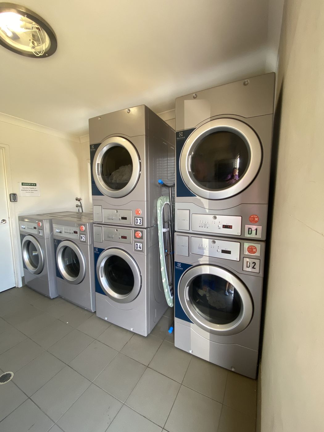 Commercial guest laundry and ironing room with washers and dryers