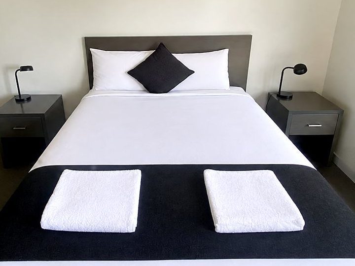 Deluxe Queen room with a queen bed, bedside tables and ensuite